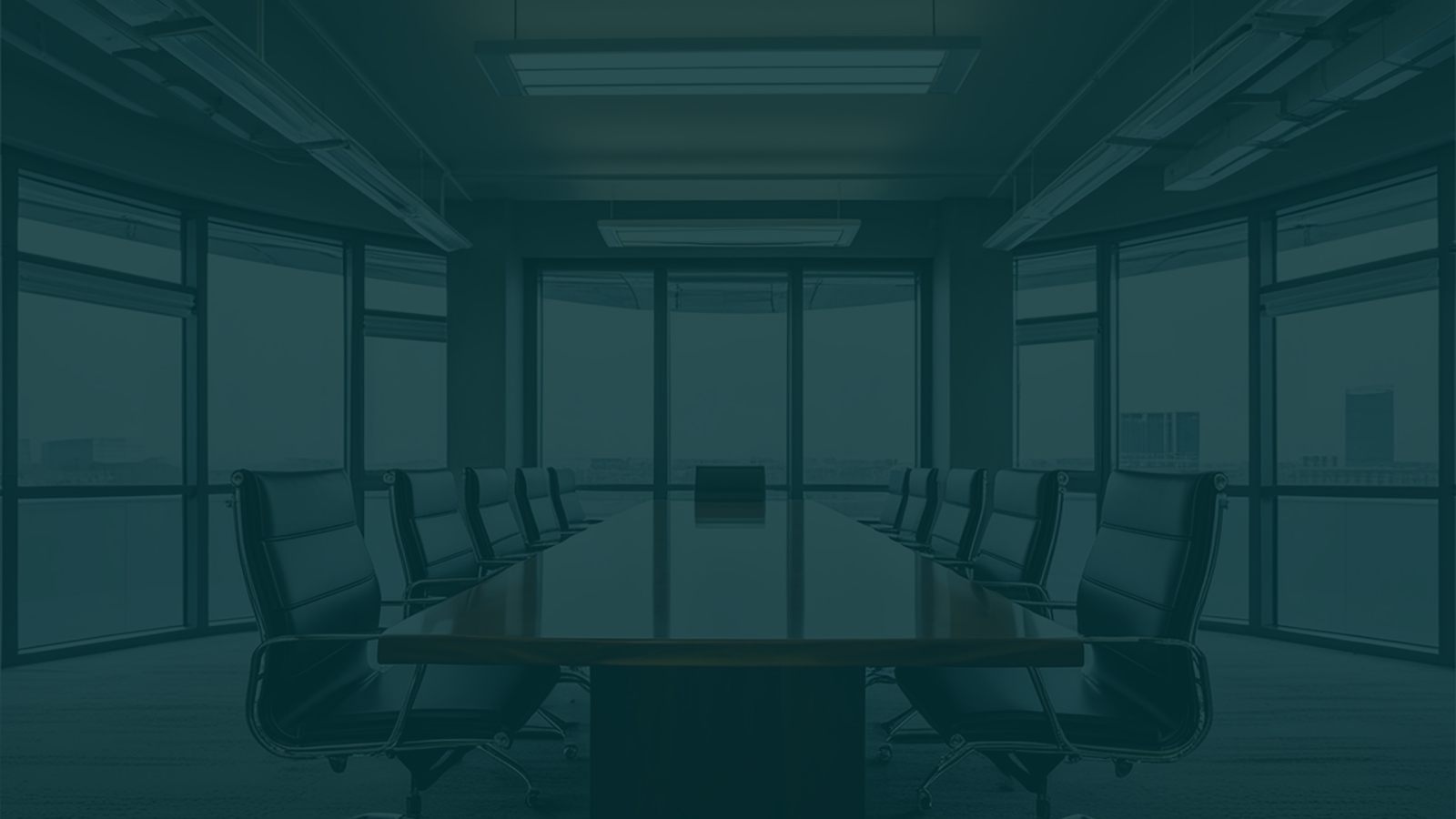 Boardroom with a long conference table and city views